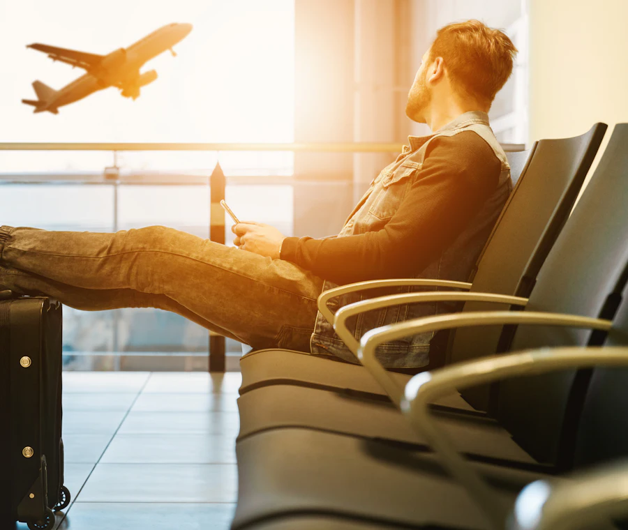 Traveler waiting at an airport as a plane takes off